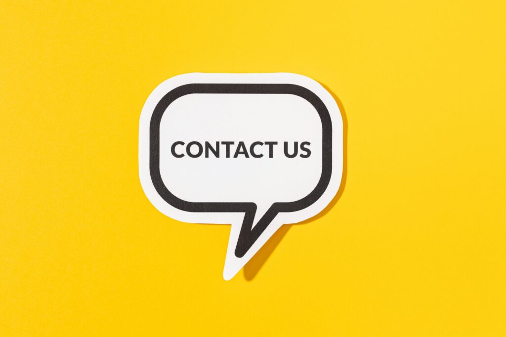 Contact Us text on speech bubble isolated on yellow background