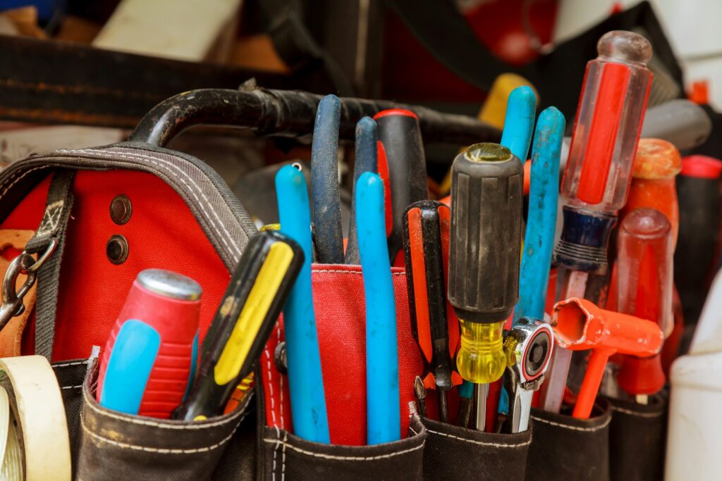 Working tool in the bag Work tools in bag on wood background.